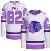Adidas Chicago Blackhawks 82 Caleb Jones Authentic White/Purple Hockey Fights Cancer Primegreen Men's NHL Jersey